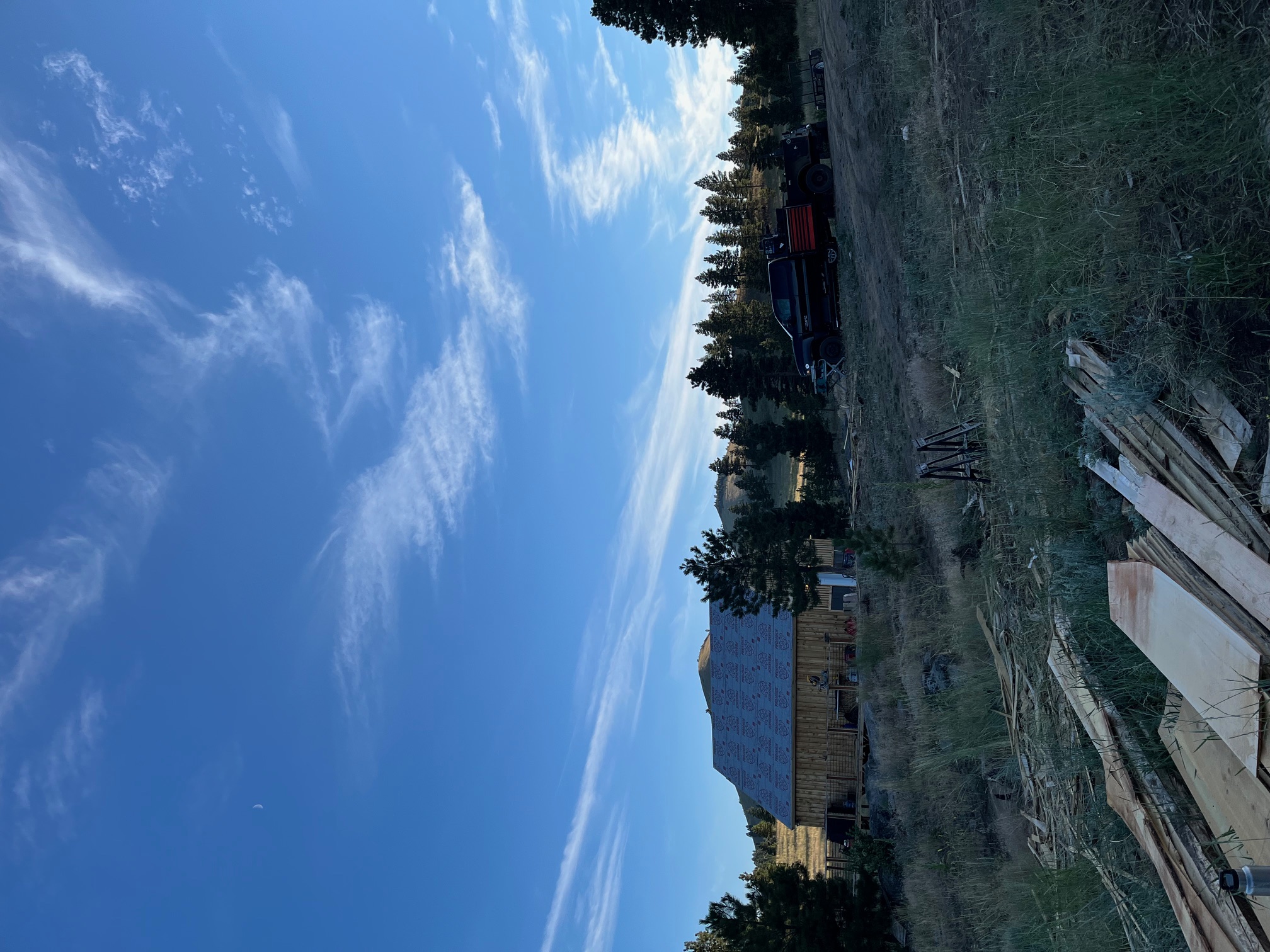 Ranch homestead and outbuildings under expansive Montana blue sky